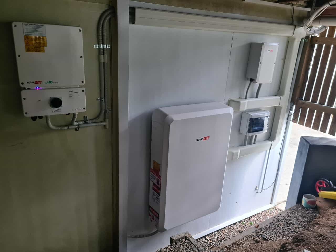 8.25kW SE Home Hub Inverter with 9.7kWh SE Battery and SE Backup Interface and Essential Circuit Sub Board installed for a 3D Energy customer on a concrete wall under the house