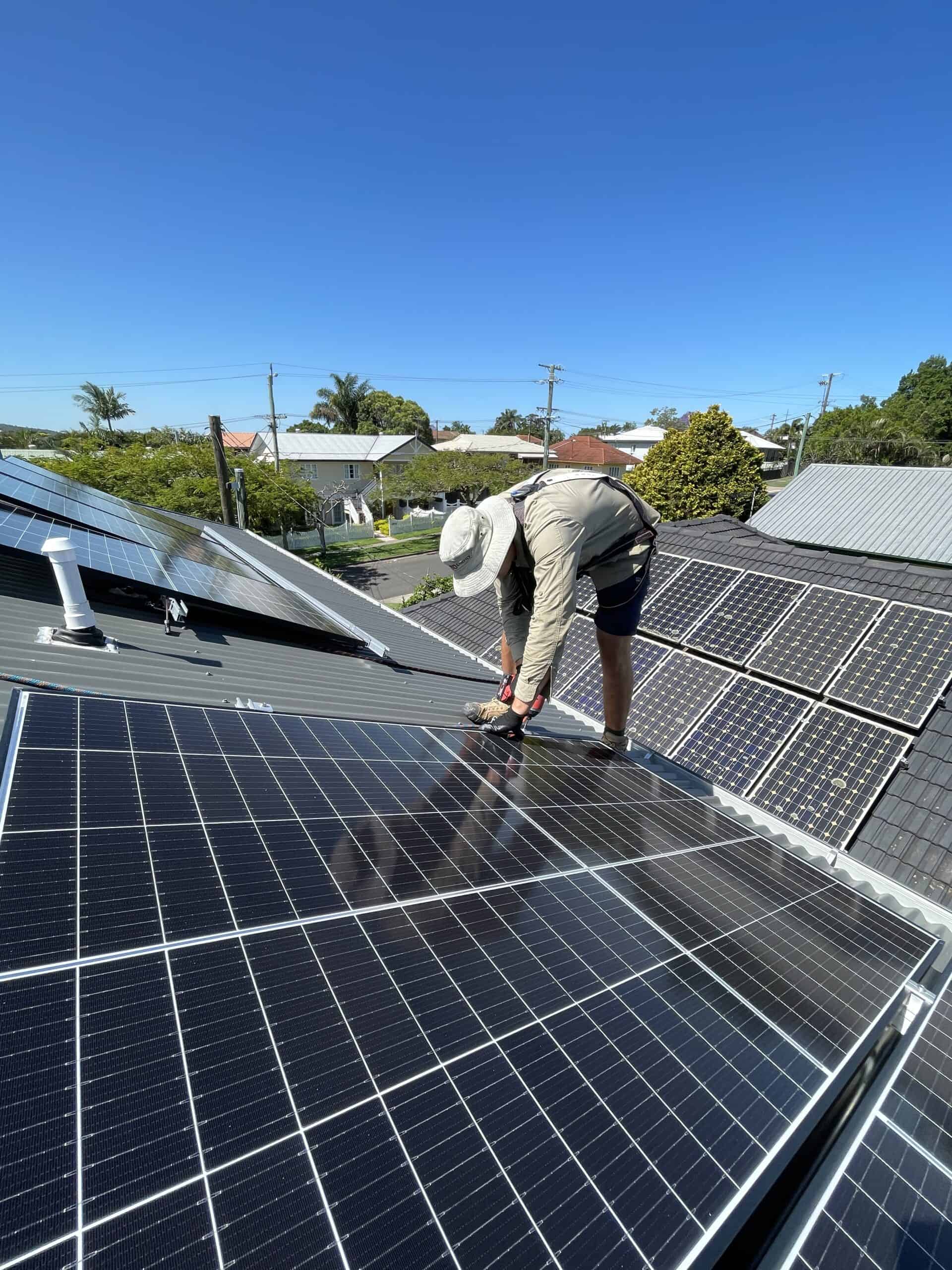 Solar panel expert installing solar panels on a roof