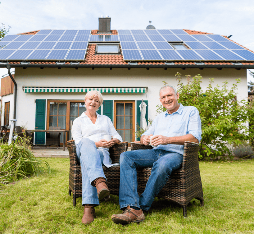 senior couple sitting solar system background at roof