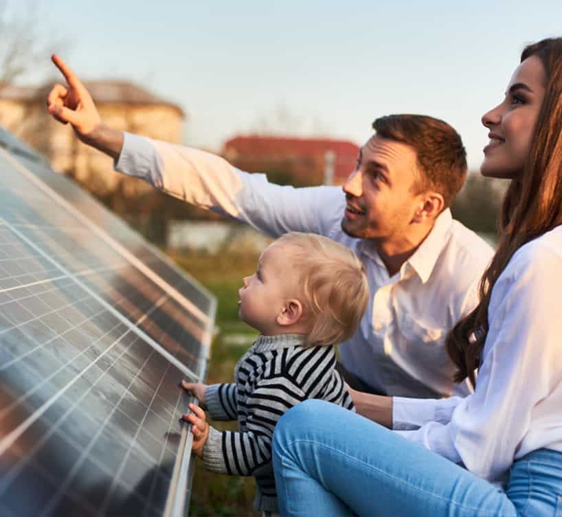 Solar panel technician with drill installing solar panels on roof