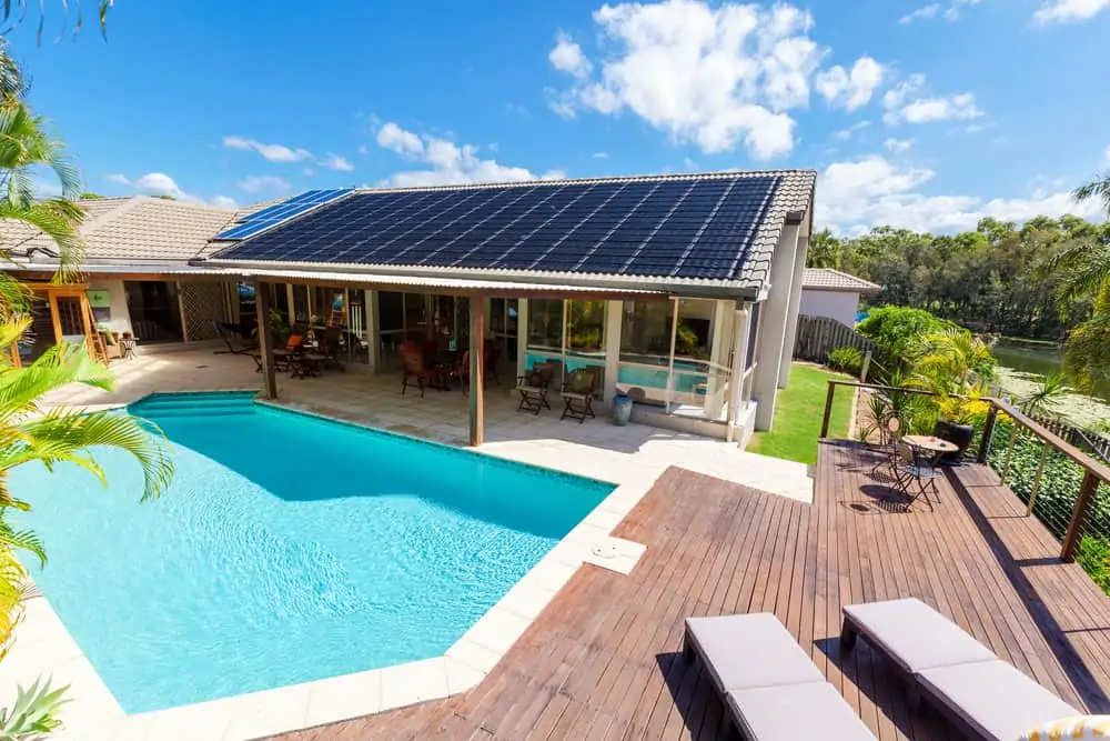 Backyard with swimming pool and solar panels on the roof