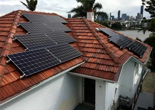Dark solar panels on a red roof